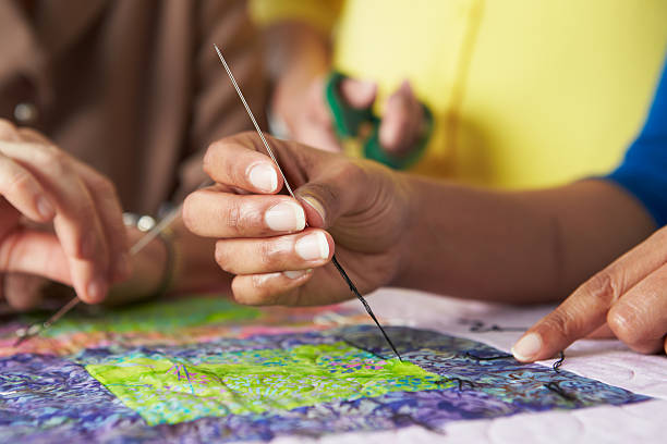Close Up Of Woman's Hand Sewing Quilt Making Adjustments
